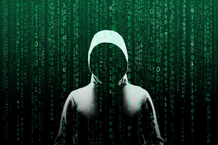 Anonymous computer hacker over abstract digital background